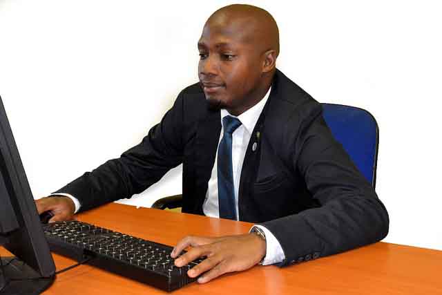 Image of african business professional working on computer